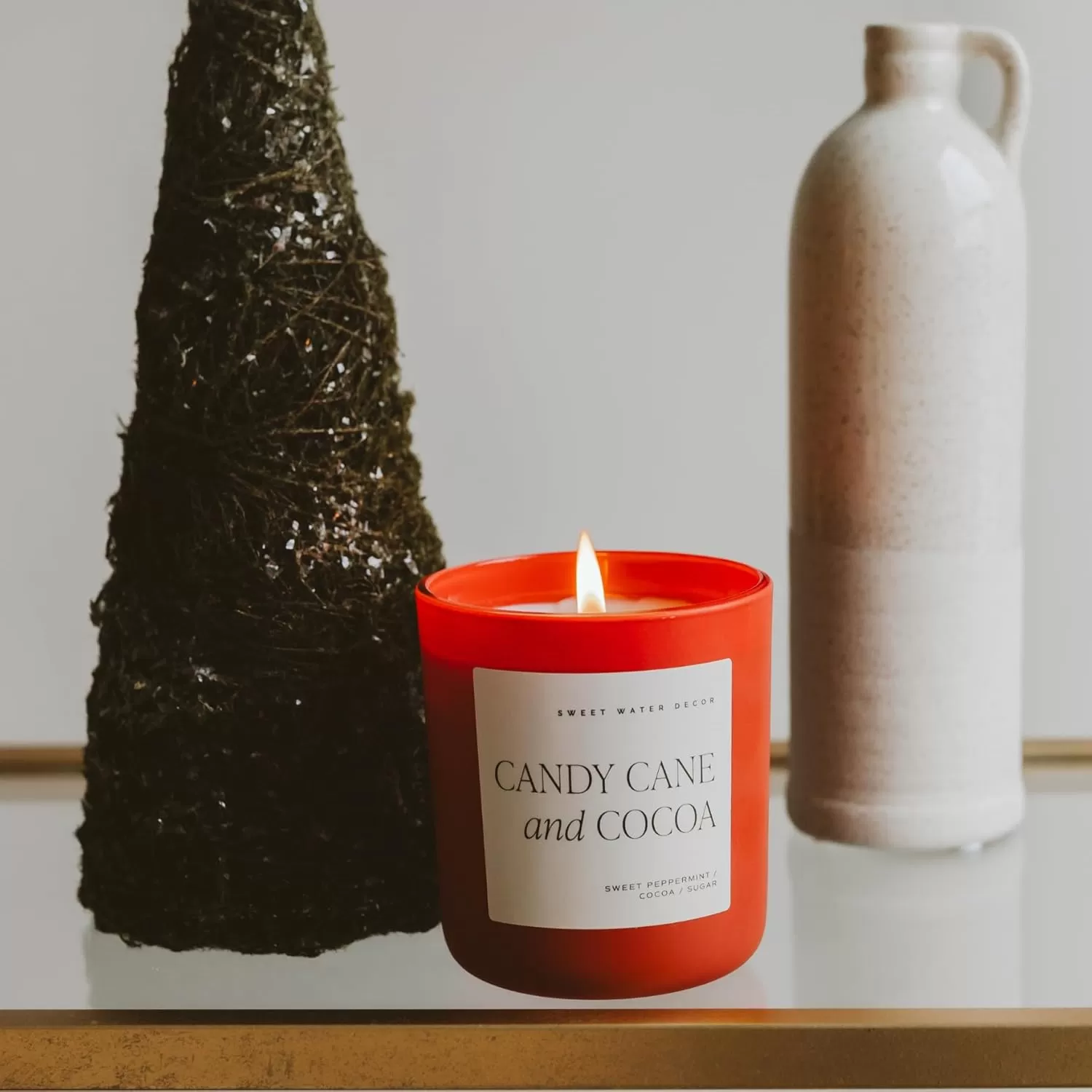 imageSweet Water Decor By The Fireside Candle  Vanilla Caramel Amber Tonka Smoky Woods Musk Winter Scented Soy Candles for Home  15oz Tan Jar 70 Hour Burn Time Made in the USARed