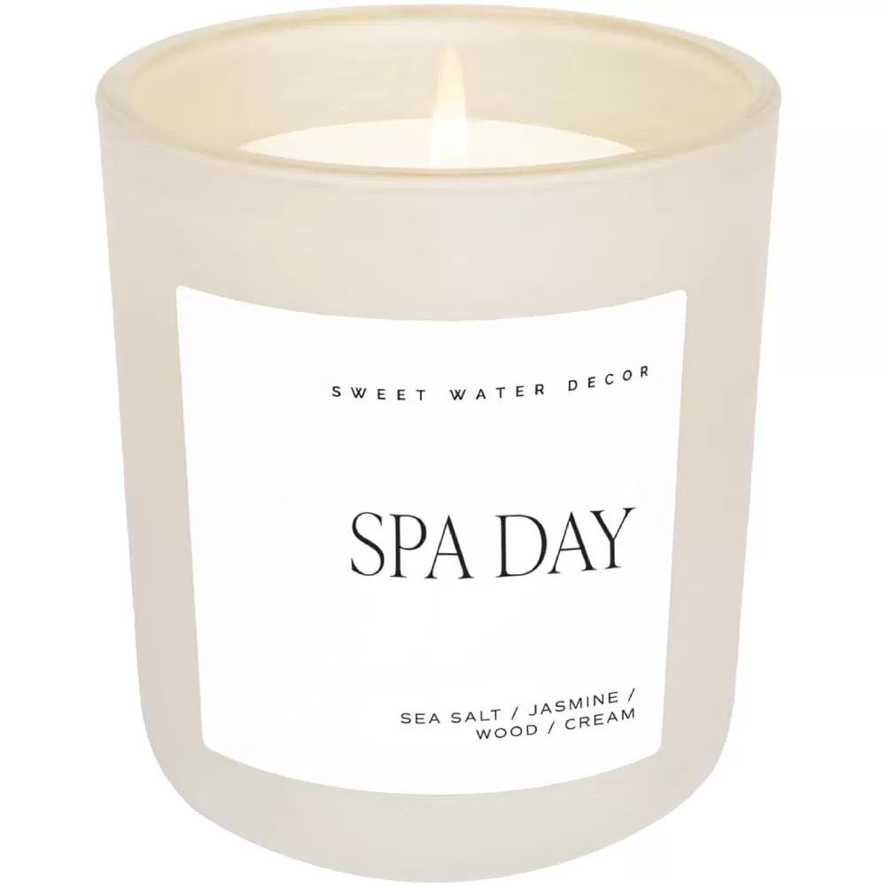 imageSweet Water Decor By The Fireside Candle  Vanilla Caramel Amber Tonka Smoky Woods Musk Winter Scented Soy Candles for Home  15oz Tan Jar 70 Hour Burn Time Made in the USATan