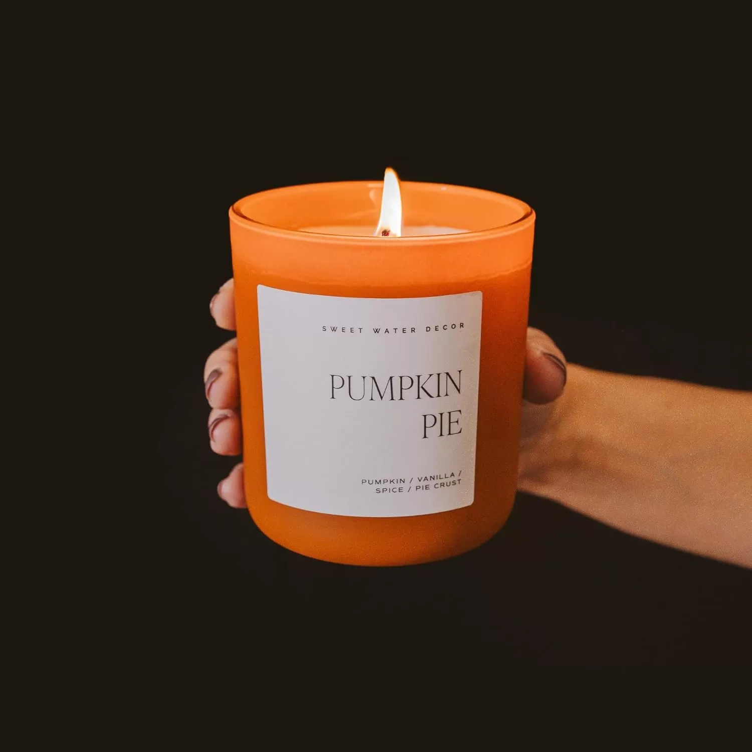 imageSweet Water Decor By The Fireside Candle  Vanilla Caramel Amber Tonka Smoky Woods Musk Winter Scented Soy Candles for Home  15oz Tan Jar 70 Hour Burn Time Made in the USAOrange