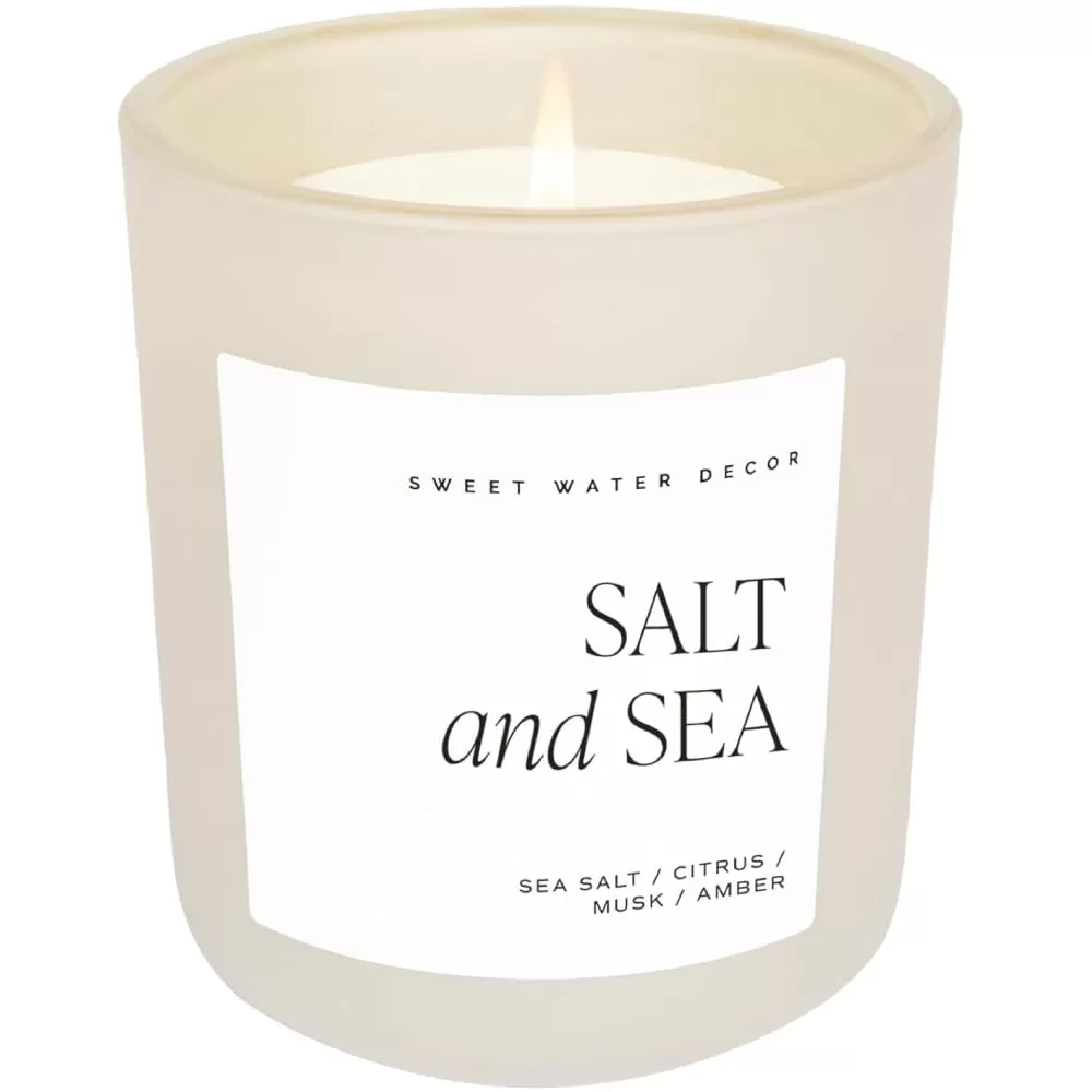 imageSweet Water Decor By The Fireside Candle  Vanilla Caramel Amber Tonka Smoky Woods Musk Winter Scented Soy Candles for Home  15oz Tan Jar 70 Hour Burn Time Made in the USATan