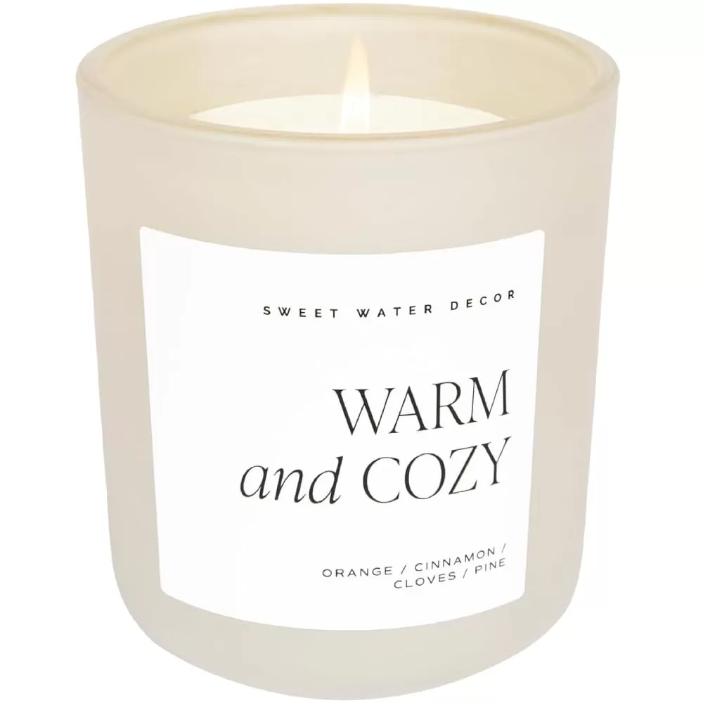 imageSweet Water Decor By The Fireside Candle  Vanilla Caramel Amber Tonka Smoky Woods Musk Winter Scented Soy Candles for Home  15oz Tan Jar 70 Hour Burn Time Made in the USATan