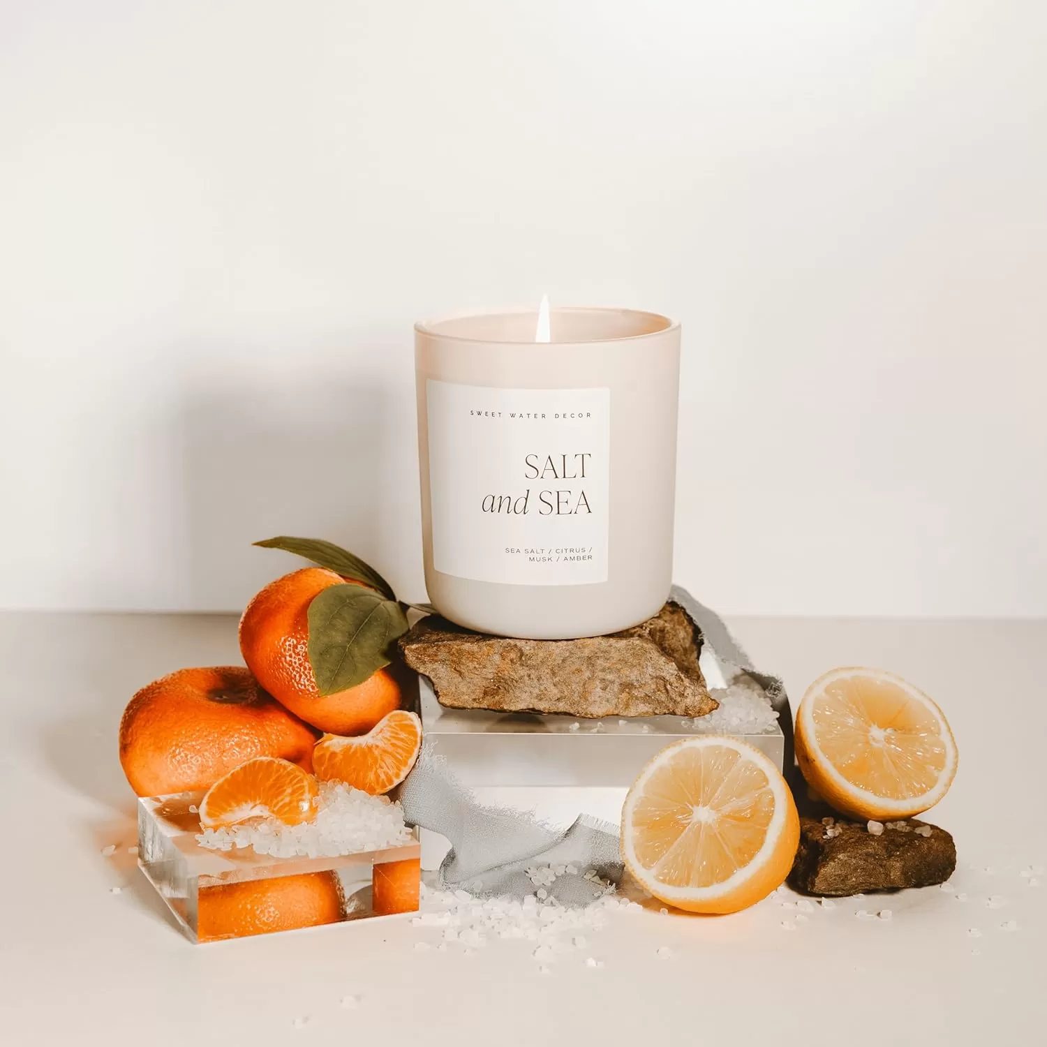 imageSweet Water Decor By The Fireside Candle  Vanilla Caramel Amber Tonka Smoky Woods Musk Winter Scented Soy Candles for Home  15oz Tan Jar 70 Hour Burn Time Made in the USATan