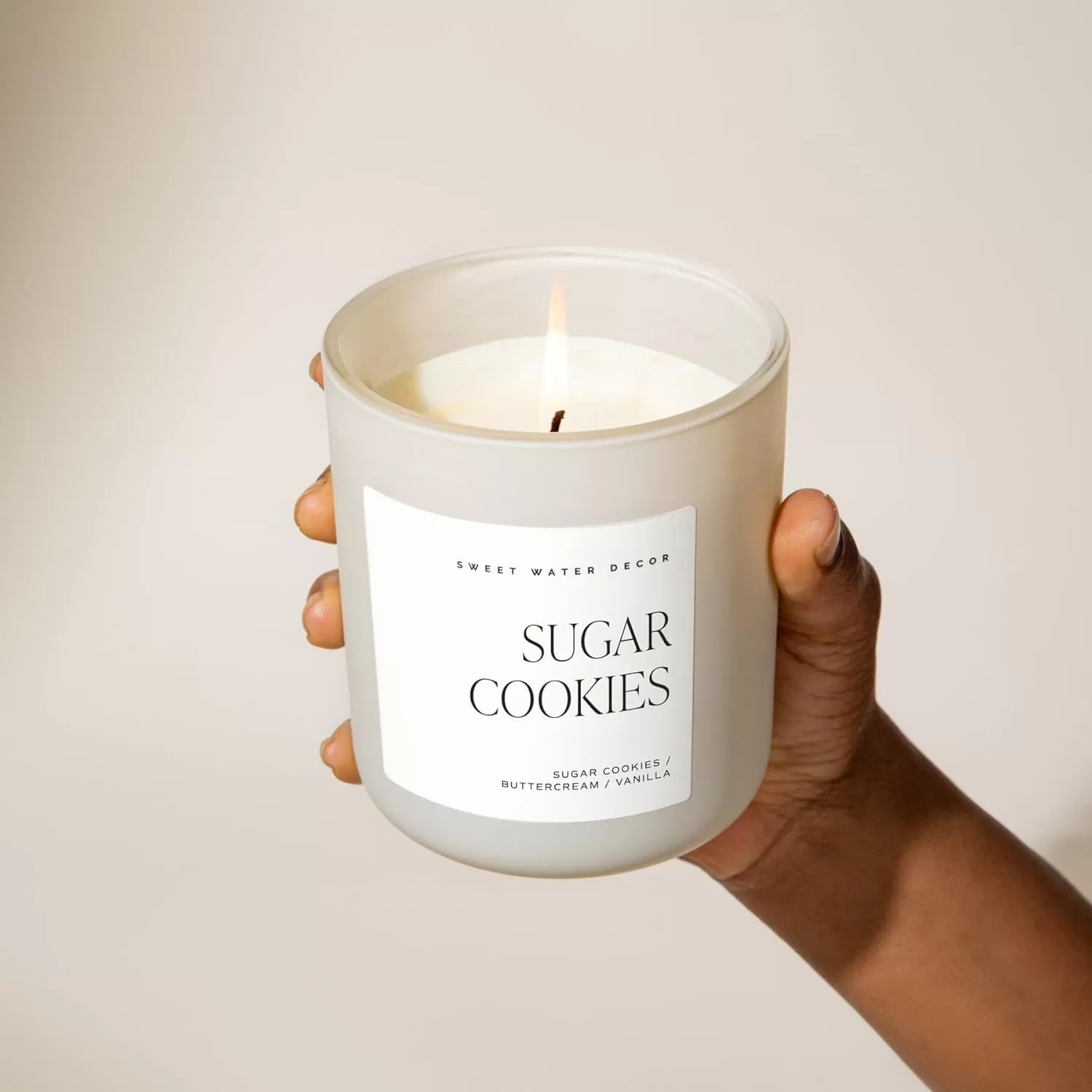 imageSweet Water Decor By The Fireside Candle  Vanilla Caramel Amber Tonka Smoky Woods Musk Winter Scented Soy Candles for Home  15oz Tan Jar 70 Hour Burn Time Made in the USATan