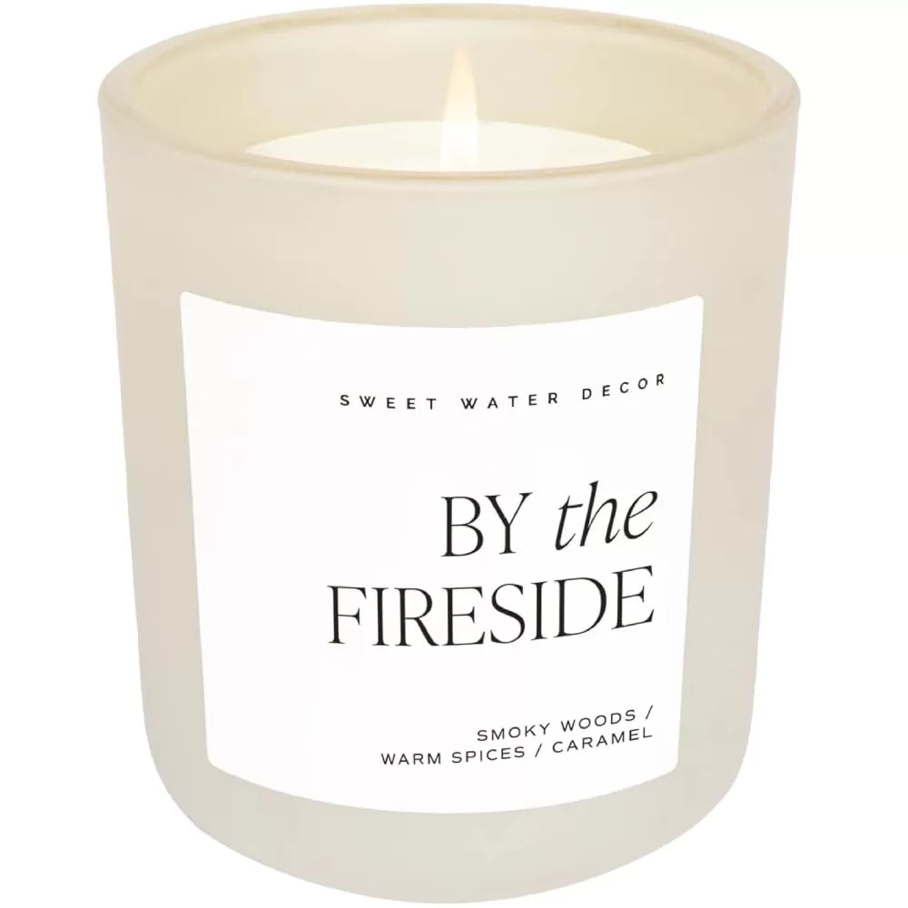 imageSweet Water Decor By The Fireside Candle  Vanilla Caramel Amber Tonka Smoky Woods Musk Winter Scented Soy Candles for Home  15oz Tan Jar 70 Hour Burn Time Made in the USATan
