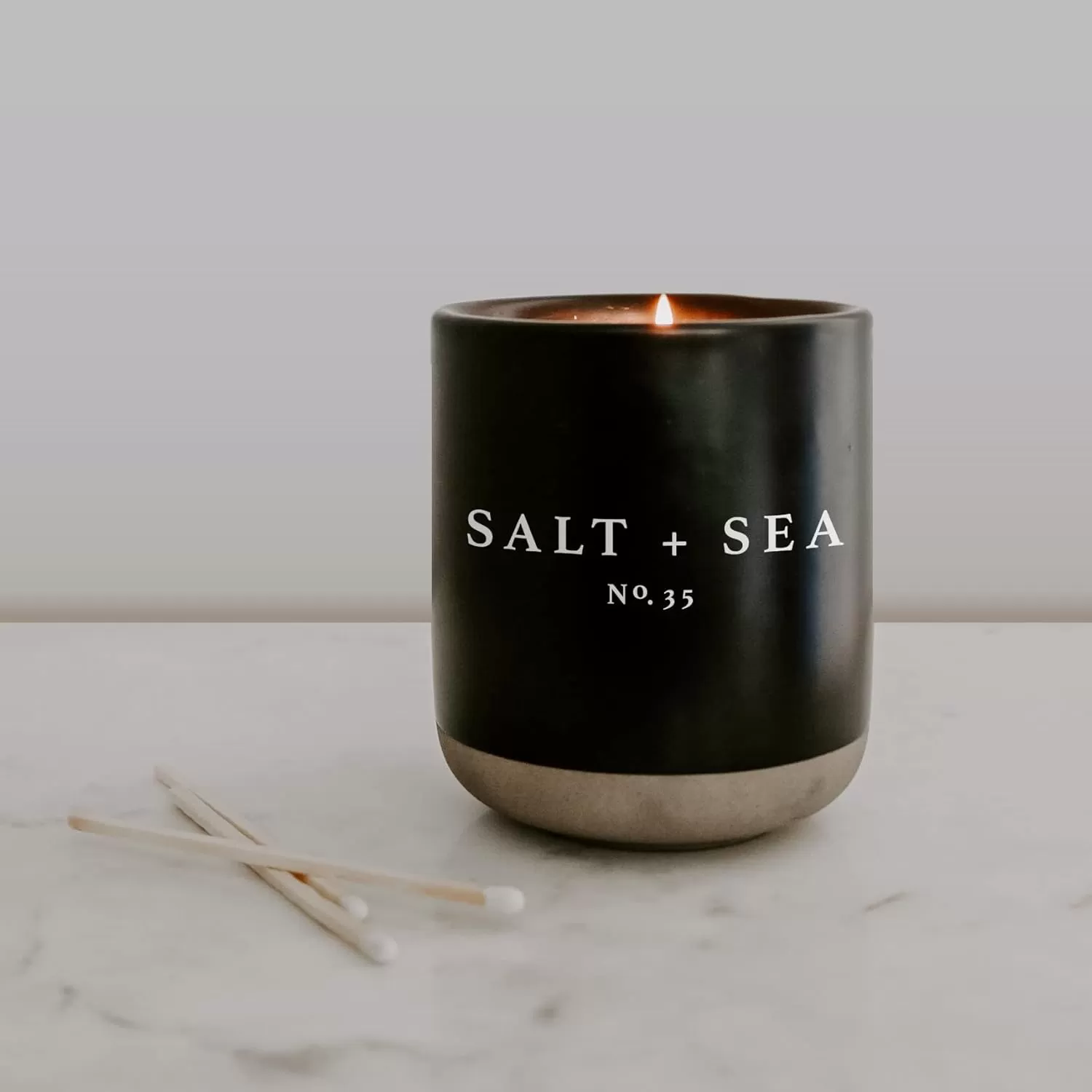 imageSweet Water Decor Christmas Candle  Apple Cider Cinnamon Fresh Cut Christmas Tree and Cookies Scented Soy Candle for Home  12oz Black Stoneware Jar 60 Hour Burn Time Made in the USASalt  Sea