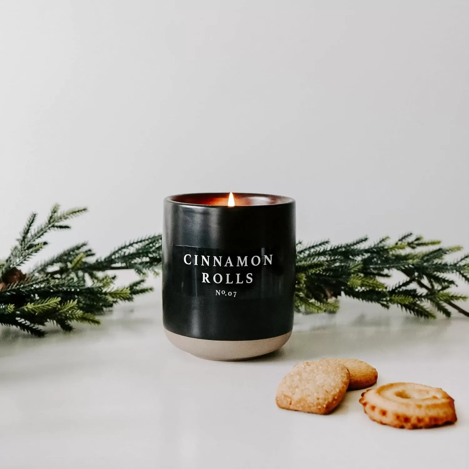 imageSweet Water Decor Christmas Candle  Apple Cider Cinnamon Fresh Cut Christmas Tree and Cookies Scented Soy Candle for Home  12oz Black Stoneware Jar 60 Hour Burn Time Made in the USACinnamon Rolls