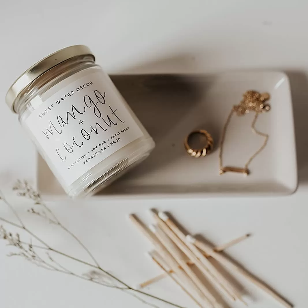 imageSweet Water Decor Christmas Tree Candle  Pine Needles Cedarwood Cypress and Evergreen Soy Holiday Scented Candles for Home  9oz Clear Jar Candle 40 Hour Burn Time Made in the USAMango and Coconut