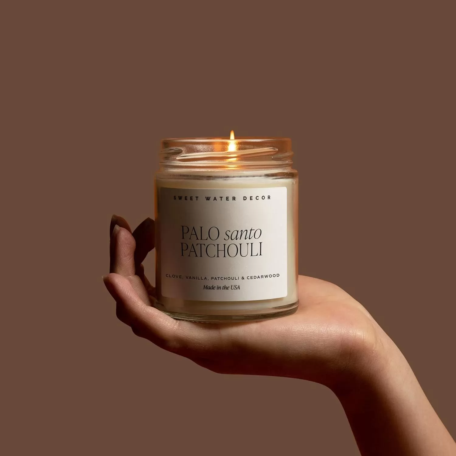 imageSweet Water Decor Relaxation Soy Candle  Eucalyptus Peppermint and Clove Scented Candles for Home  9oz Clear Jar  Gold Lid 40 Hour Burn Time Made in the USAPalo Santo Patchouli