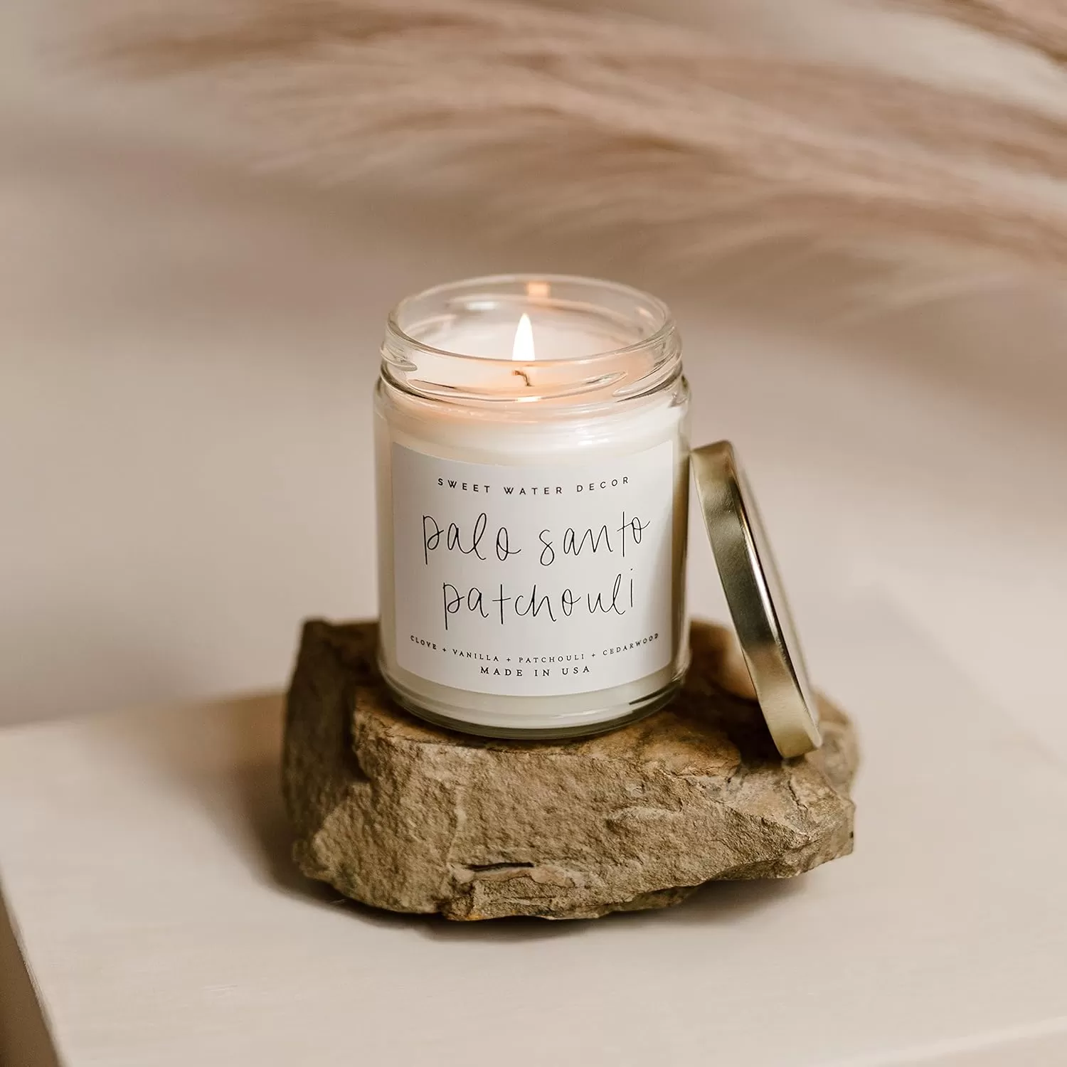 imageSweet Water Decor Relaxation Soy Candle  Eucalyptus Peppermint and Clove Scented Candles for Home  9oz Clear Jar  Gold Lid 40 Hour Burn Time Made in the USAPalo Santo Patchouli