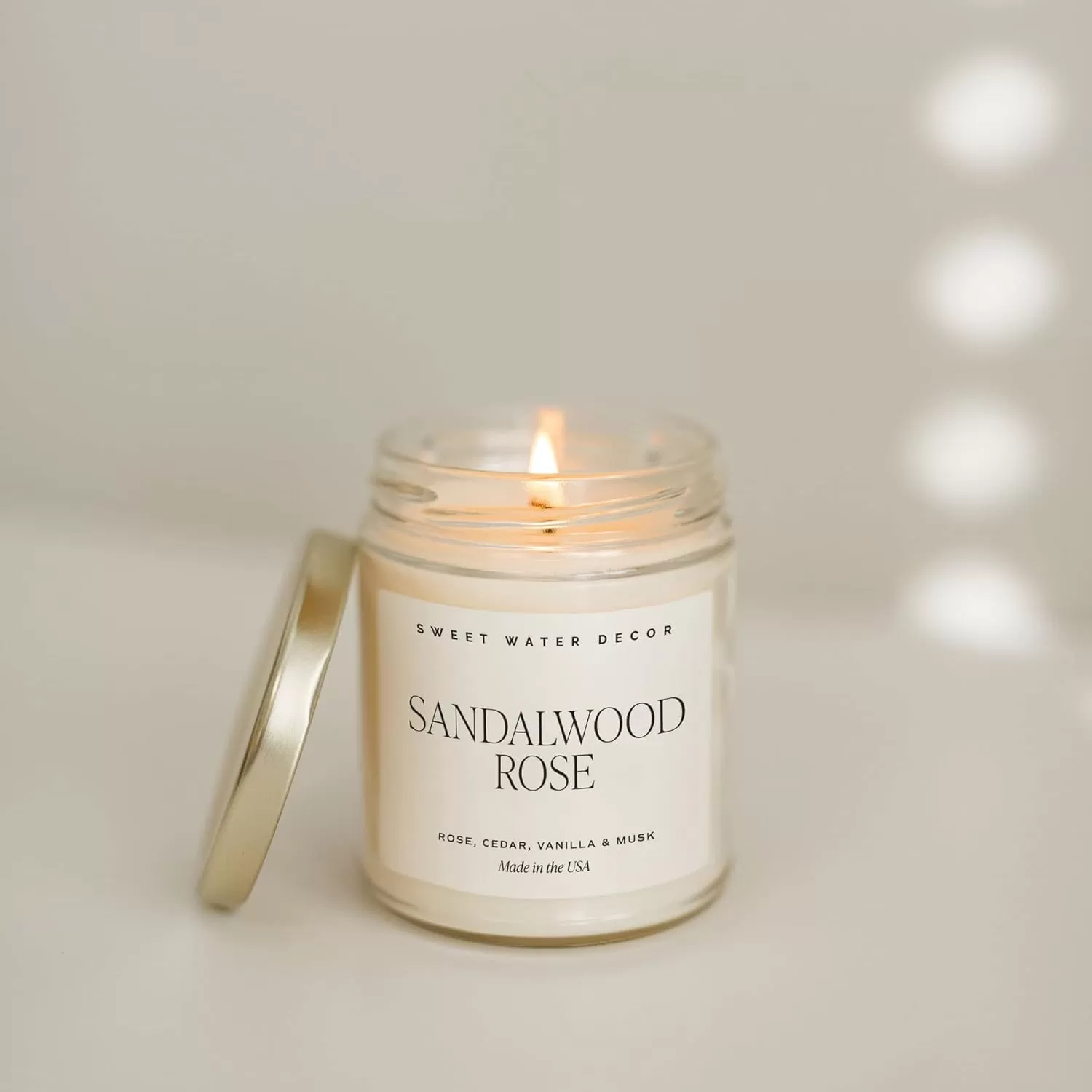 imageSweet Water Decor Spa Day Soy Candle  Sea Salt Jasmine Wood and Cream Scented Candles for Home  9oz Clear Jar  Gold Lid 40 Hour Burn Time Made in the USASandalwood Rose