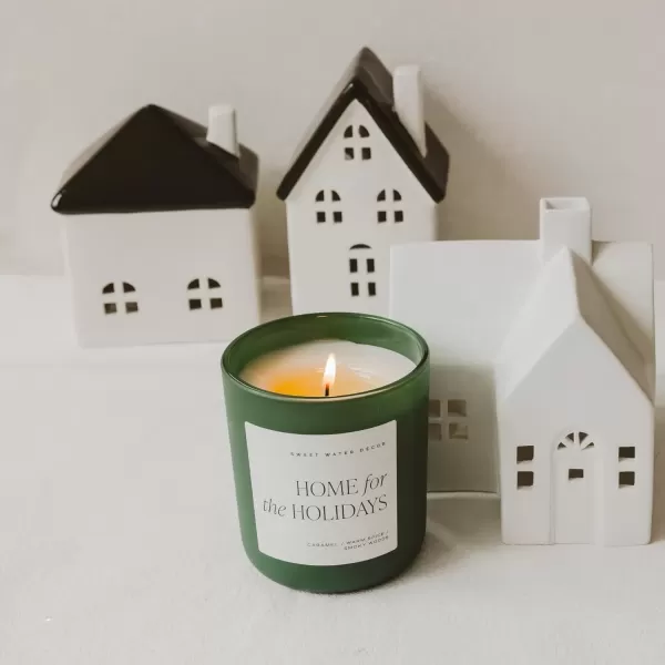 imageSweet Water Decor By The Fireside Candle  Vanilla Caramel Amber Tonka Smoky Woods Musk Winter Scented Soy Candles for Home  15oz Tan Jar 70 Hour Burn Time Made in the USAGreen