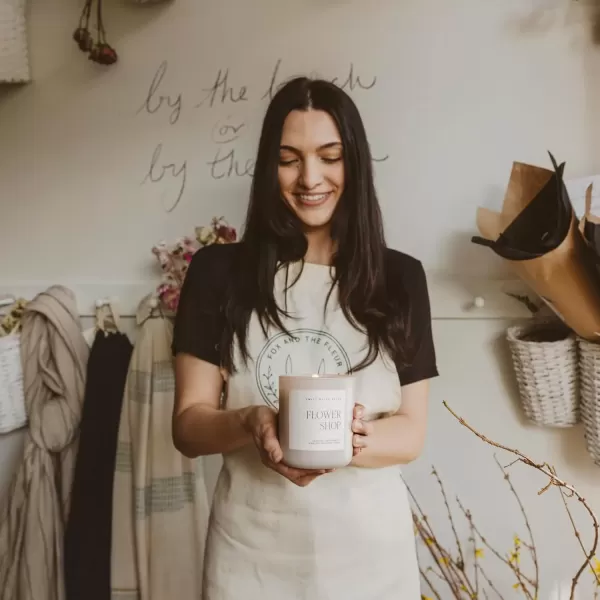 imageSweet Water Decor By The Fireside Candle  Vanilla Caramel Amber Tonka Smoky Woods Musk Winter Scented Soy Candles for Home  15oz Tan Jar 70 Hour Burn Time Made in the USATan