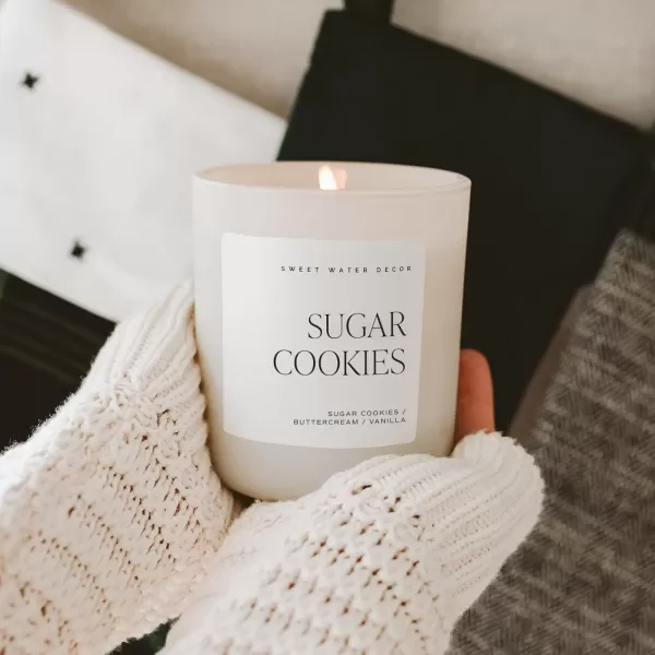 imageSweet Water Decor By The Fireside Candle  Vanilla Caramel Amber Tonka Smoky Woods Musk Winter Scented Soy Candles for Home  15oz Tan Jar 70 Hour Burn Time Made in the USATan