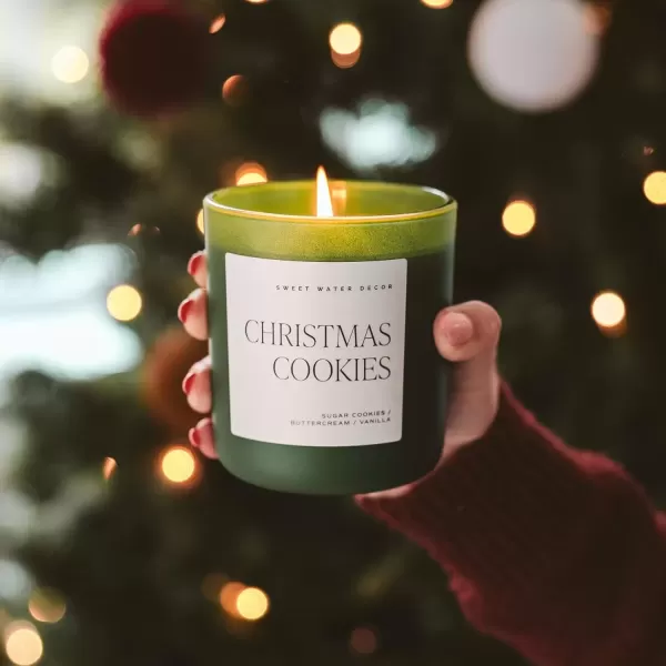 imageSweet Water Decor By The Fireside Candle  Vanilla Caramel Amber Tonka Smoky Woods Musk Winter Scented Soy Candles for Home  15oz Tan Jar 70 Hour Burn Time Made in the USAGreen