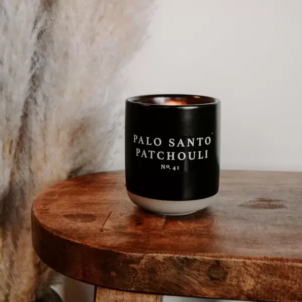 imageSweet Water Decor Christmas Candle  Apple Cider Cinnamon Fresh Cut Christmas Tree and Cookies Scented Soy Candle for Home  12oz Black Stoneware Jar 60 Hour Burn Time Made in the USAPalo Santo Patchouli