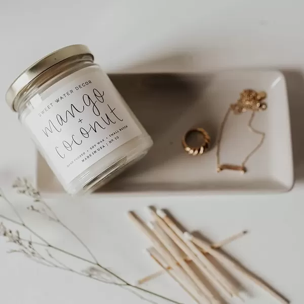 imageSweet Water Decor Christmas Tree Candle  Pine Needles Cedarwood Cypress and Evergreen Soy Holiday Scented Candles for Home  9oz Clear Jar Candle 40 Hour Burn Time Made in the USAMango and Coconut