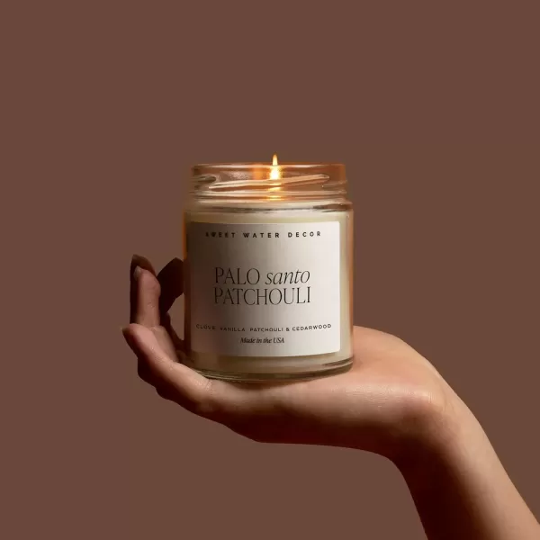 imageSweet Water Decor Relaxation Soy Candle  Eucalyptus Peppermint and Clove Scented Candles for Home  9oz Clear Jar  Gold Lid 40 Hour Burn Time Made in the USAPalo Santo Patchouli