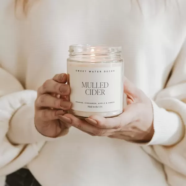 imageSweet Water Decor Spa Day Soy Candle  Sea Salt Jasmine Wood and Cream Scented Candles for Home  9oz Clear Jar  Gold Lid 40 Hour Burn Time Made in the USAMulled Cider