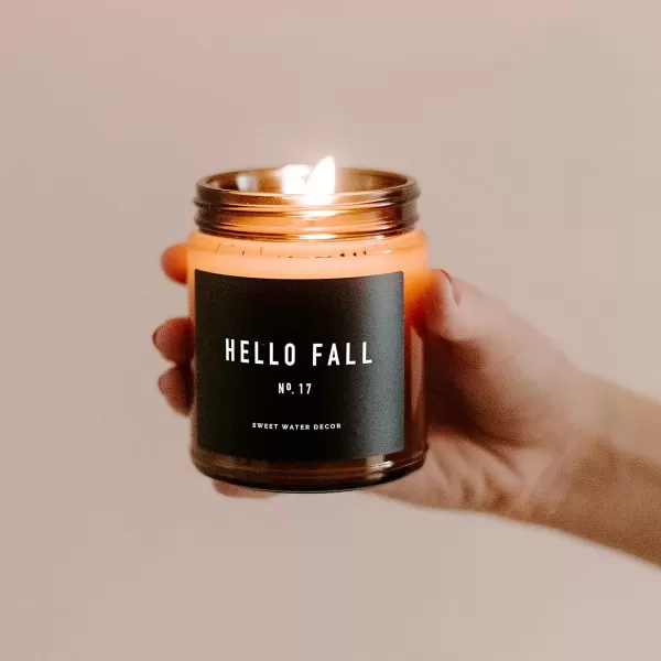 imageSweet Water Decor Hello Fall Candle No 17  Cider Cinnamon Cloves Apple and Nutmeg Scented Soy Wax Candle for Home  9oz Amber Jar with Black Lid 40 Hour Burn Time Made in The USA Hello FallHello Fall