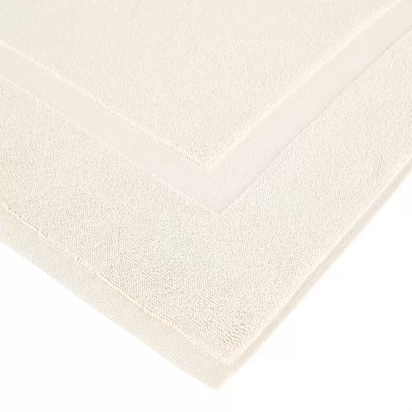 imageAmazon Basics Absorbent Cotton Machine Washable Bath Rug Mat for Shower Bright White 31quot L x 20quot WCream