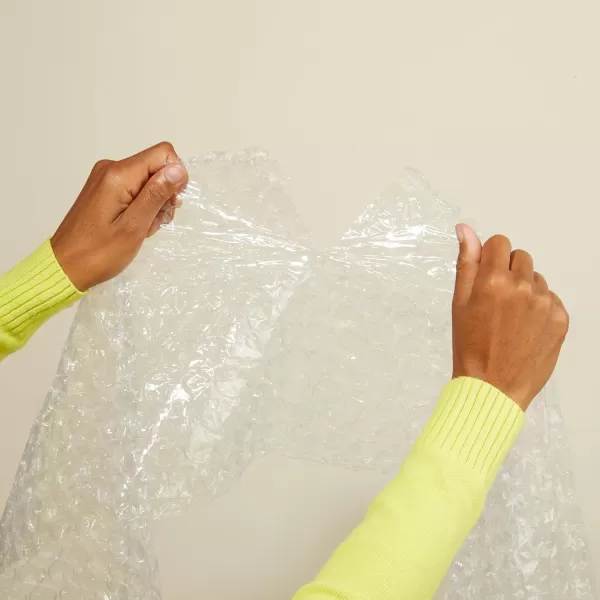 imageAmazon Basics Perforated Bubble Cushioning Wrap Large Clear 516quot 12Inch x 100Foot Long RollClear