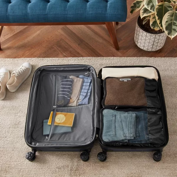 imageAmazon Basics Lightweight Packing Cubes for Travel 4 Piece Set With Double Zipper Pulls and Mesh Top Panel 100 Durable Polyester Small Sky BlueBlack