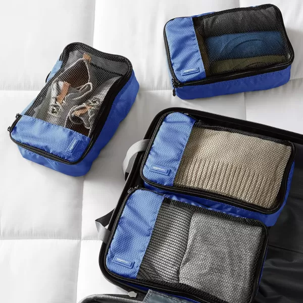 imageAmazon Basics Lightweight Packing Cubes for Travel 4 Piece Set With Double Zipper Pulls and Mesh Top Panel 100 Durable Polyester Small Sky BlueBlue