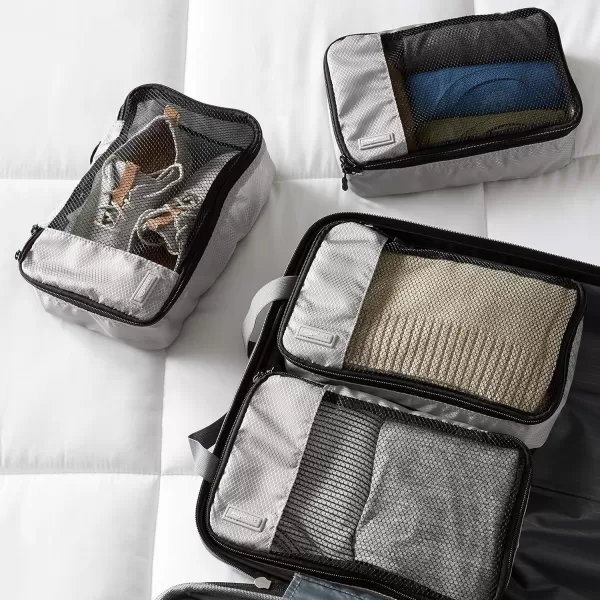imageAmazon Basics Lightweight Packing Cubes for Travel 4 Piece Set With Double Zipper Pulls and Mesh Top Panel 100 Durable Polyester Small Sky BlueGray