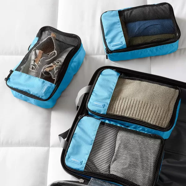 imageAmazon Basics Lightweight Packing Cubes for Travel 4 Piece Set With Double Zipper Pulls and Mesh Top Panel 100 Durable Polyester Small Sky BlueSky Blue