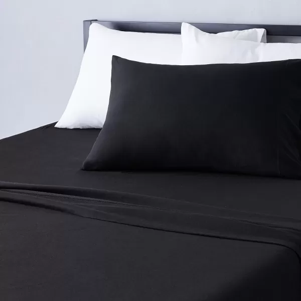 imageAmazon Basics 3 Piece Bed Sheets Set 100 Cotton Jersey Includes Super Soft Flat and Fitted Sheets Pillowcase 28 x 52 Inches Toddler White SolidBlack